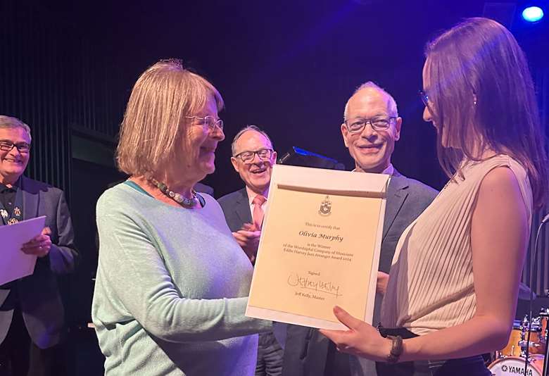 The Master, Senior Warden and Alec Dankworth look on as Peggy Harvey presents the Harvey Award for Arranging 2024 to Olivia Murphy